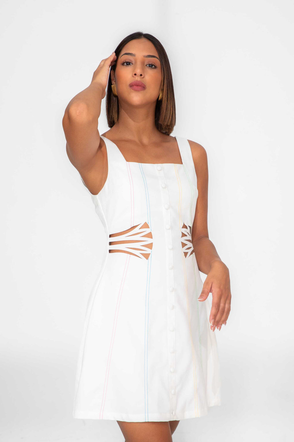 Woman wearing a white dress with cut-out design on a white background Clep