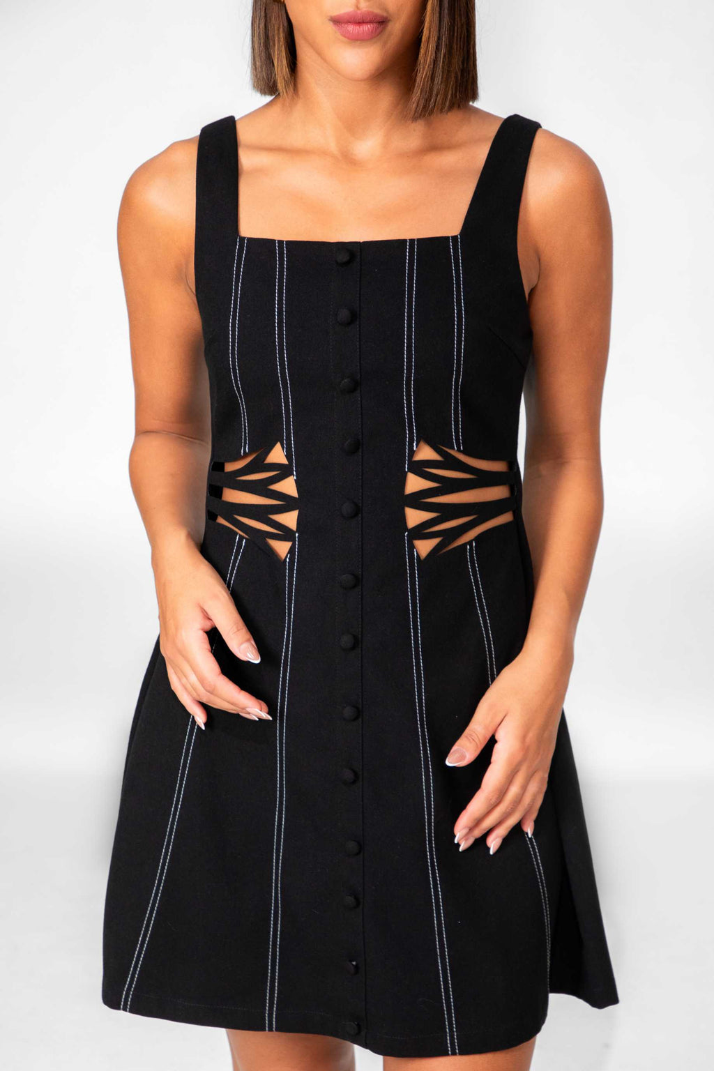 Black dress with cut-out design on a white background Clep