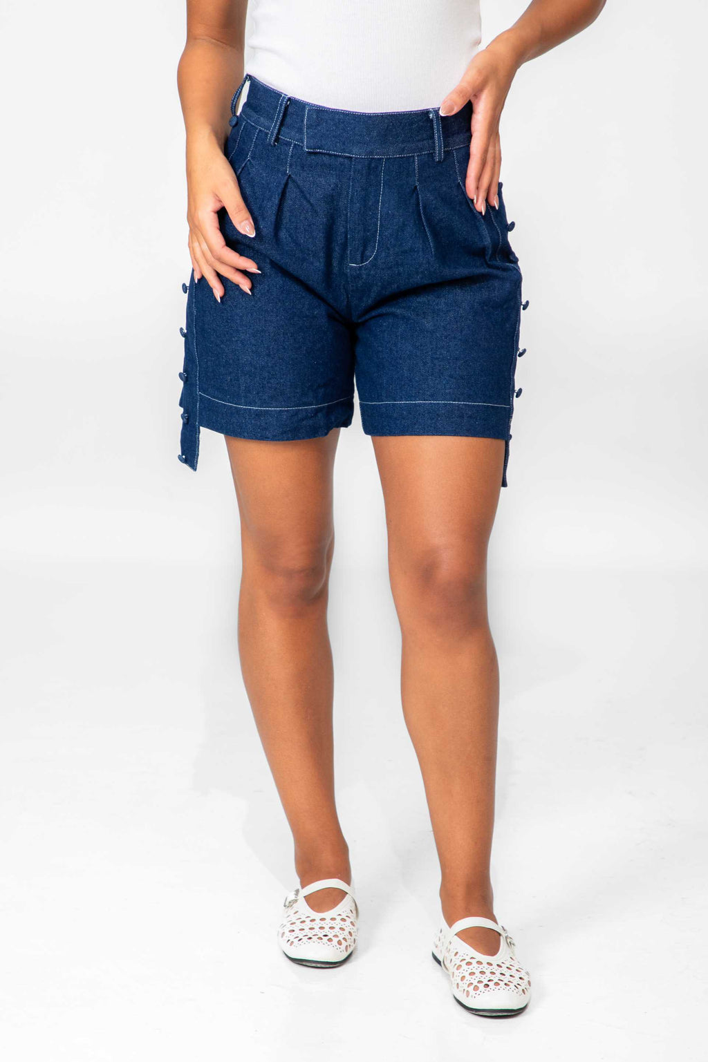 Person wearing blue denim shorts on a white background Clep