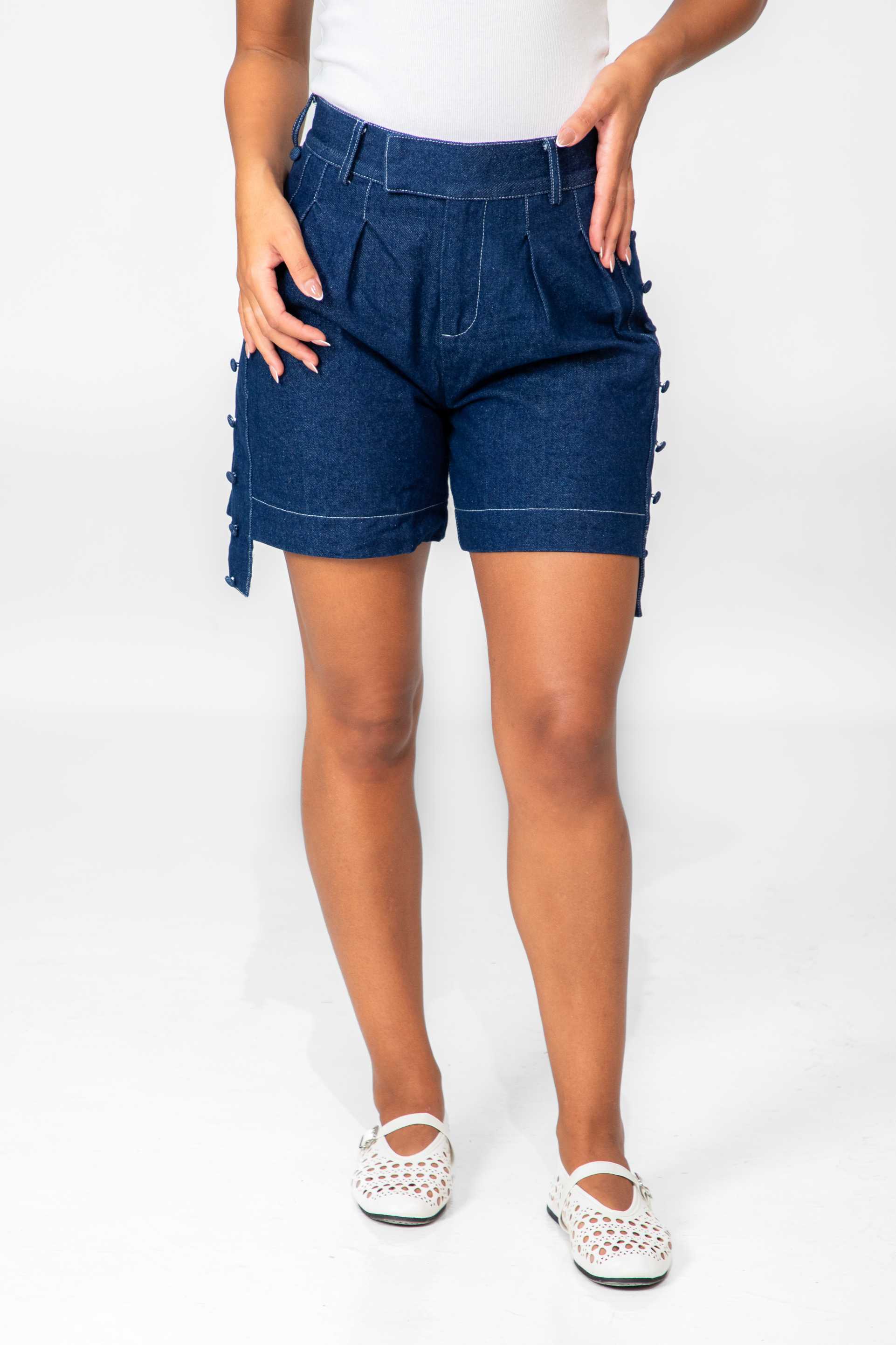 Person wearing blue denim shorts on a white background Clep