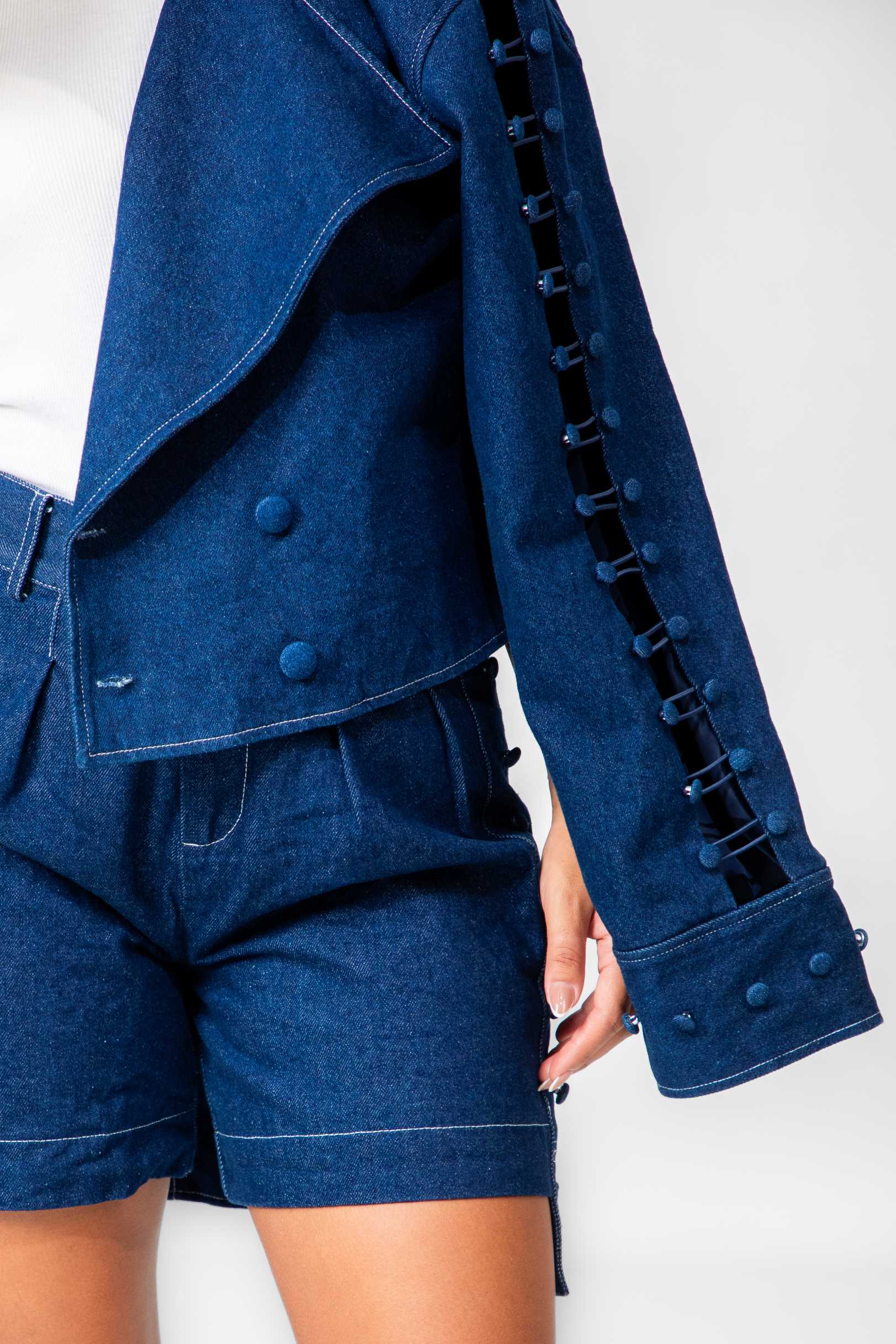 Blue denim jacket with button details and shorts on a white background Clep