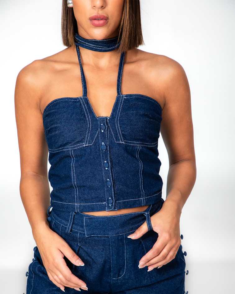 Woman wearing a blue denim outfit with a white background Clep